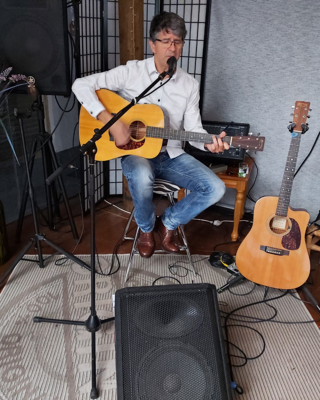 Musician playing guitar at the open mic and karaoke setup