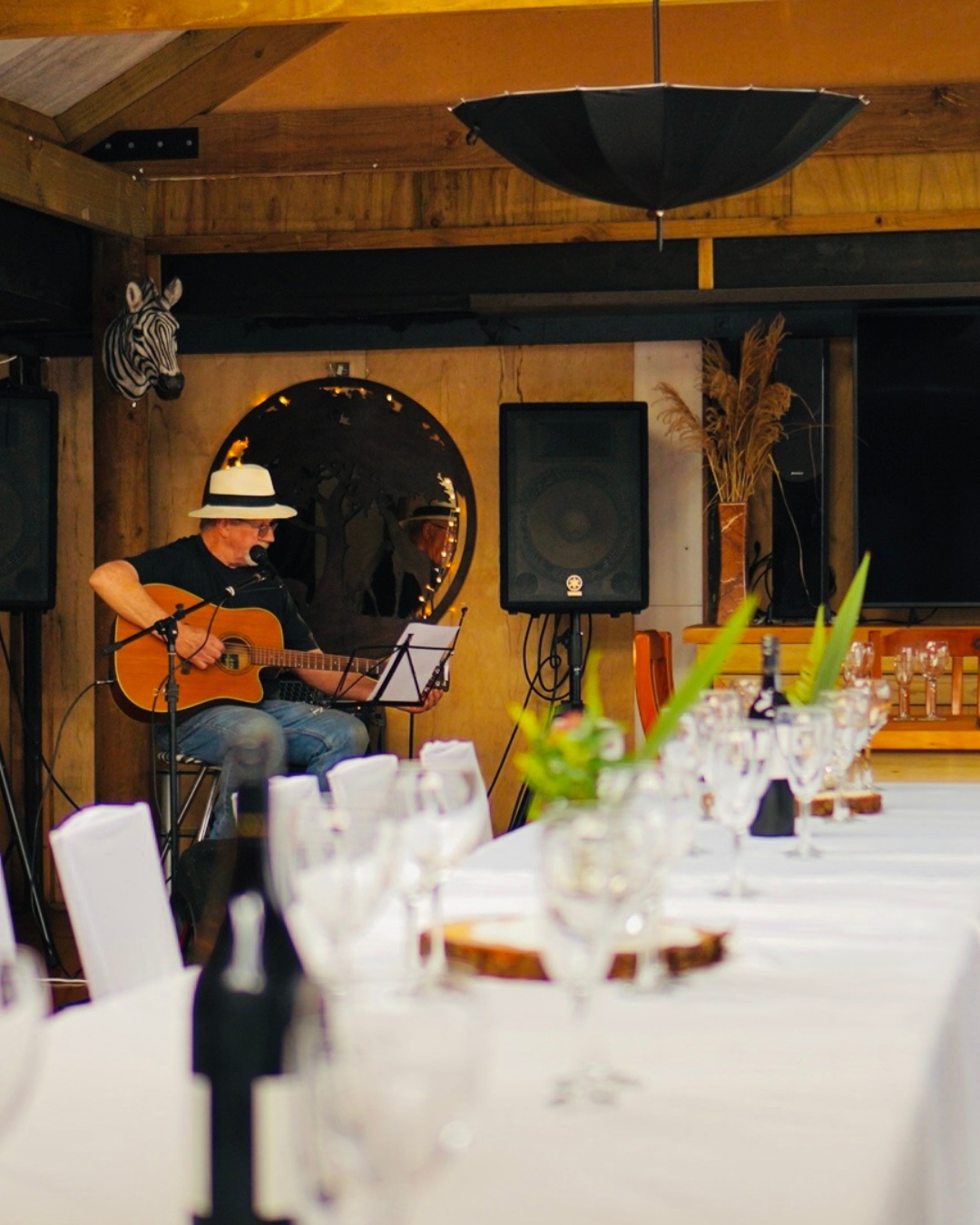 Les performing live acoustic music on guitar at Te Popo Gardens